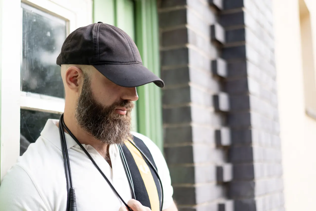 Alexx Eon beside a green door